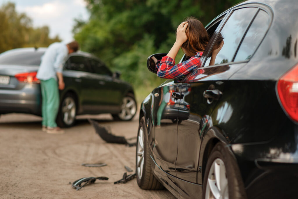 Male and female drivers after car accident on road