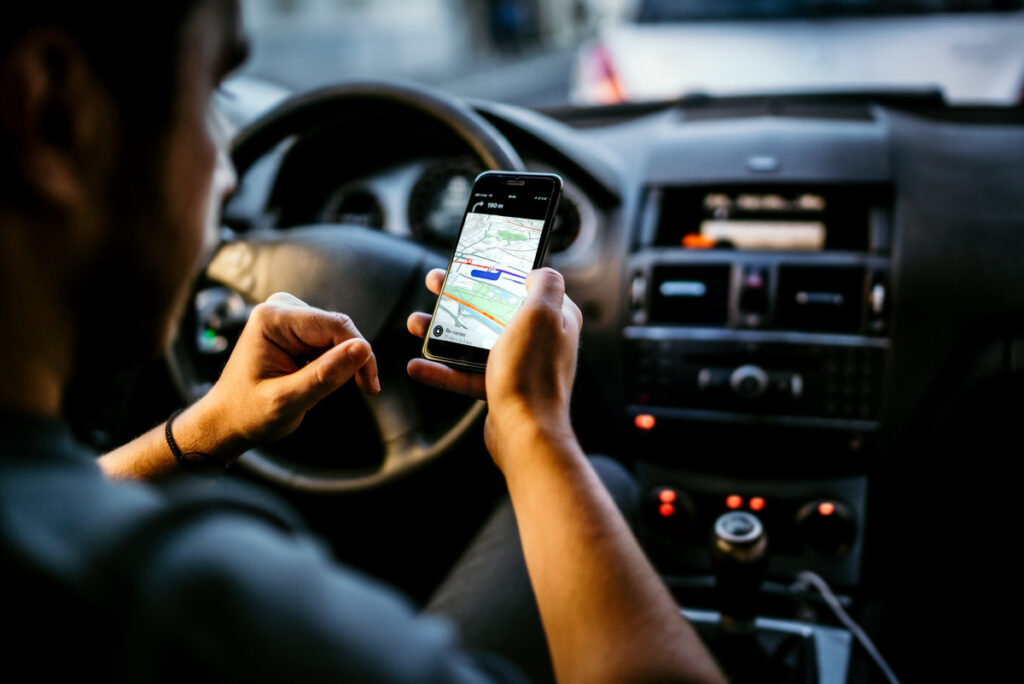 GPS and online Map to Route Destination. Man using technology and network connection for gps tracking