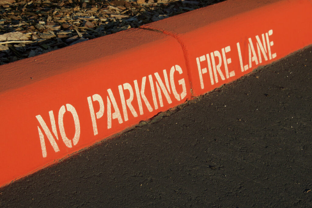Painted red curb with no parking and fire lane