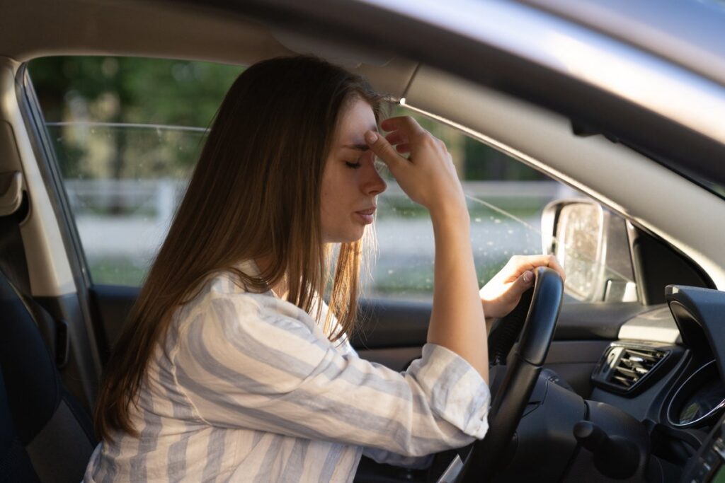 Tired driver holding the steering wheel while driving drowsy